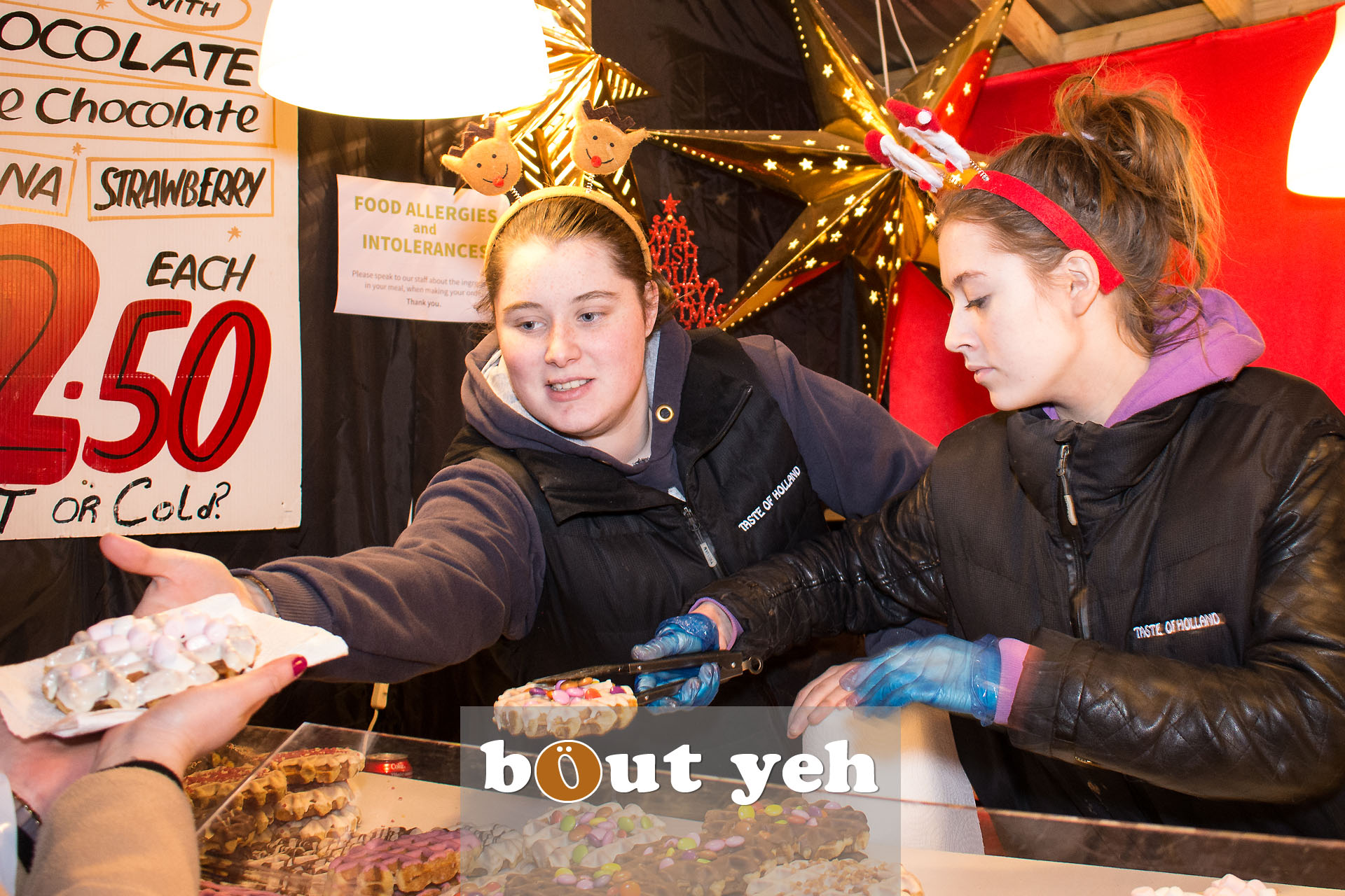 Two women at Belgian waffle stand, Belfast Continental Christmas Market, City Hall, Belfast, Northern Ireland - bout yeh photographers Belfast photo 3290.