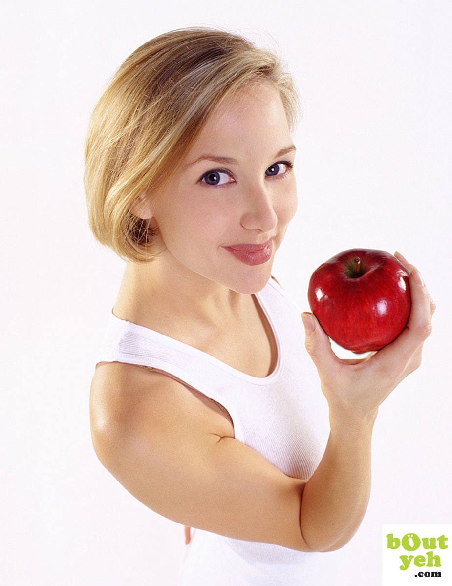 Portfolio portrait photograph of young woman holding red apple.