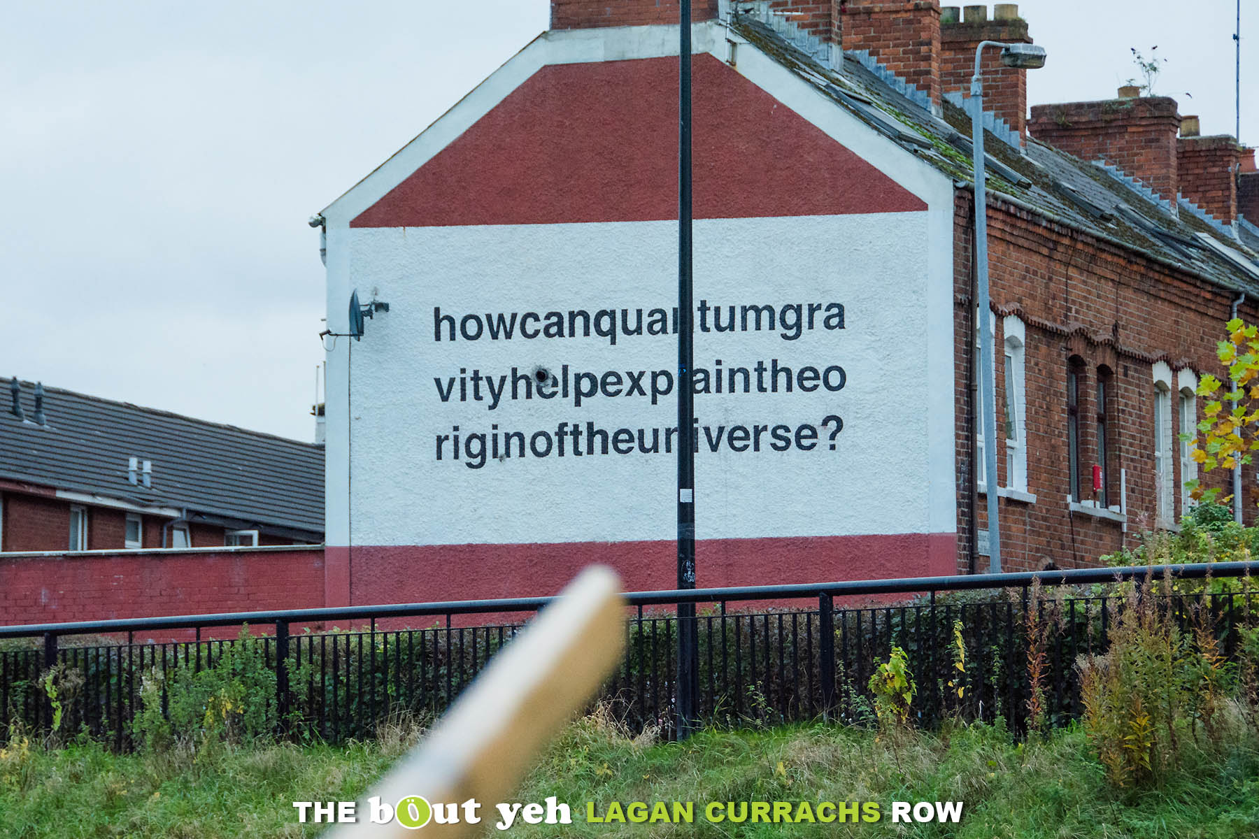 Belfast wall mural depicting the words How can quantum gravity explain the origin of the universe, seen from the Bout Yeh Lagan Currachs row - photo 9248.