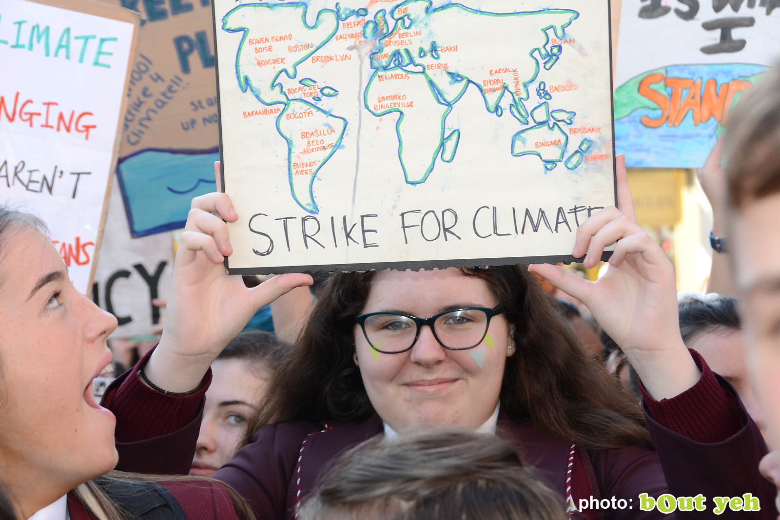 Schoolgirl holding map of the world banner at the strike for climate protest in Belfast. Photo 8943 by Bout Yeh photographers Belfast