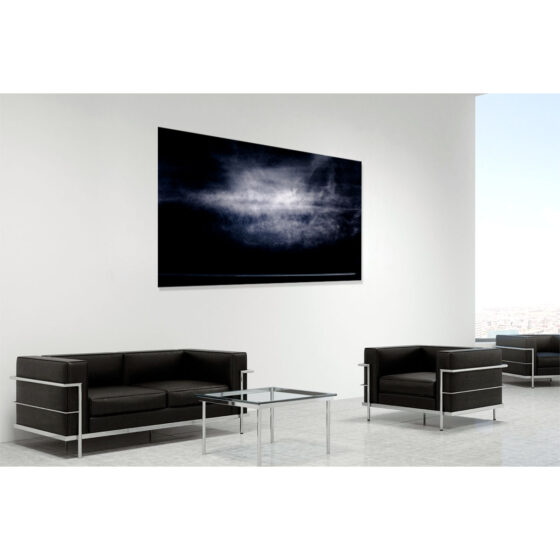 An airplane's jet stream is dwarfed below a gigantic cloud formation over Cave Hill, Northern Ireland - contemporary fine art photograph of Ireland by Stephen S T Bradley entitled Fellow Travellers. Print shown in room setting.