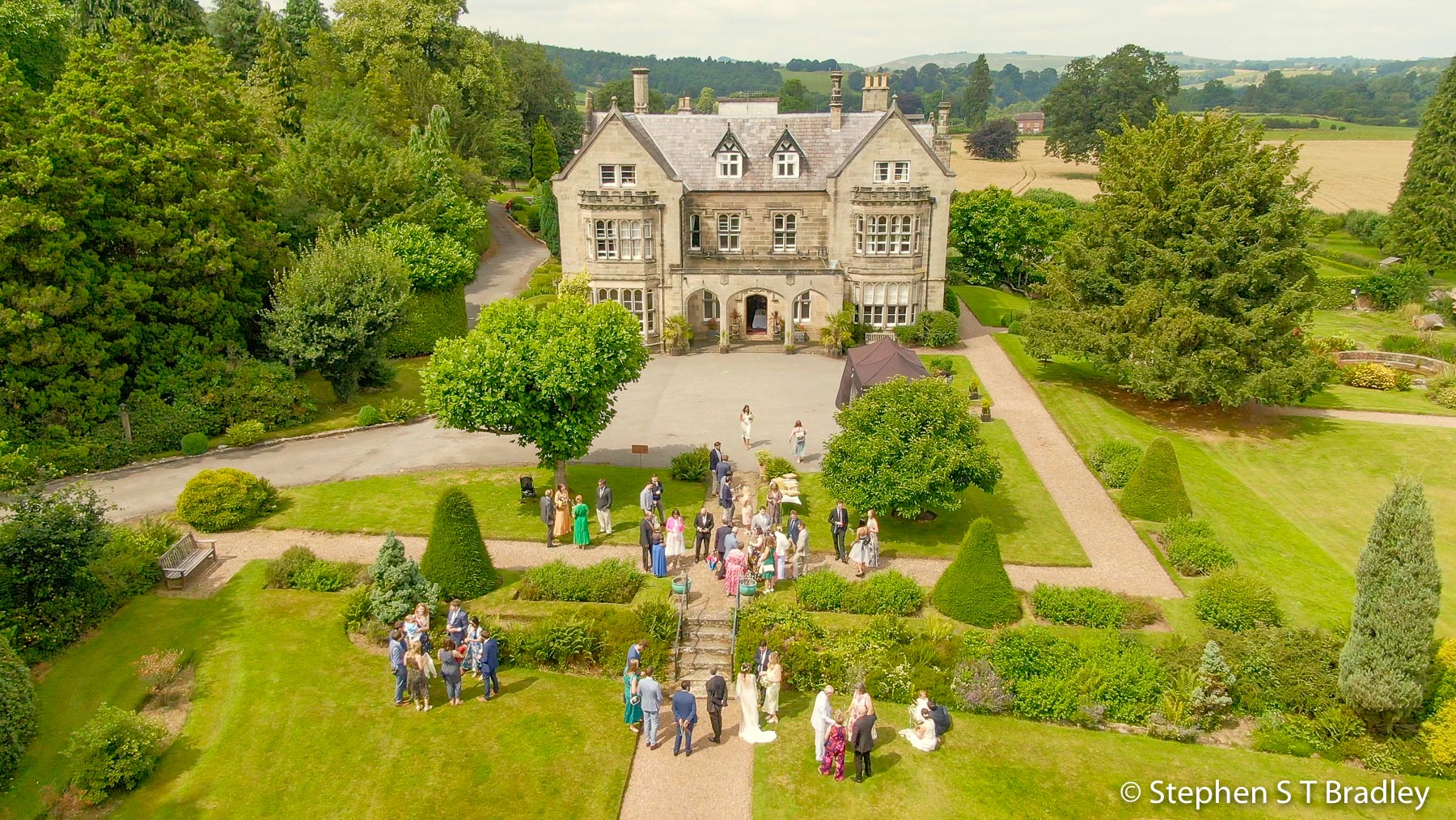 Wedding video screenshot showing the wedding party in front of Birdsgrove House, Derbyshire, England - wedding video produced for Patrick and Kate by Bout Yeh, an aerial drone photography and video production services provider working in Belfast and throughout Northern Ireland. Wedding video screenshot 8